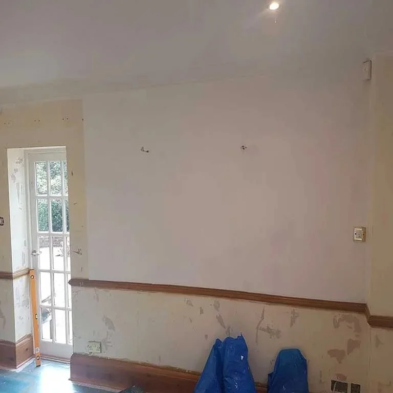 Dado rail and woodwork stripped back with the wall above freshly filled and sanded, mid-preparation on a Bourne Decorators interior job