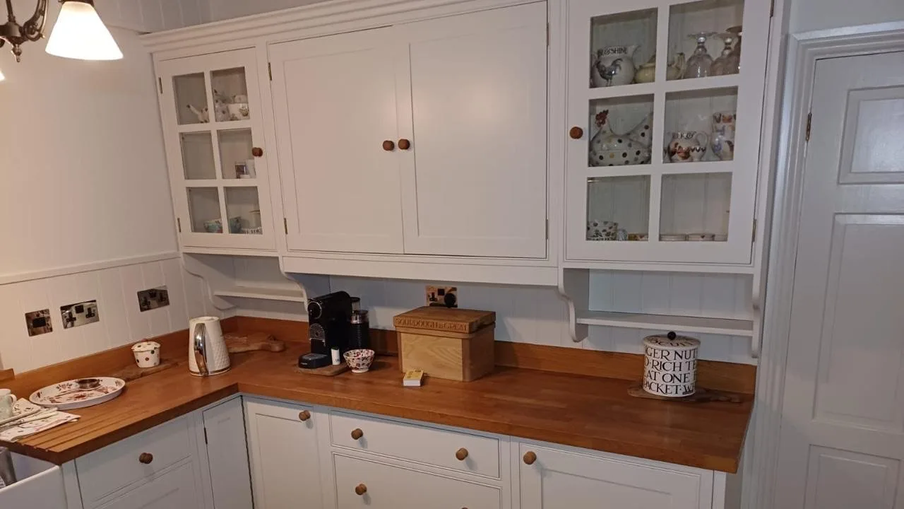 Hand finished shaker kitchen cabinets painted in soft white with oak worktops, kitchen respray by Bourne Decorators