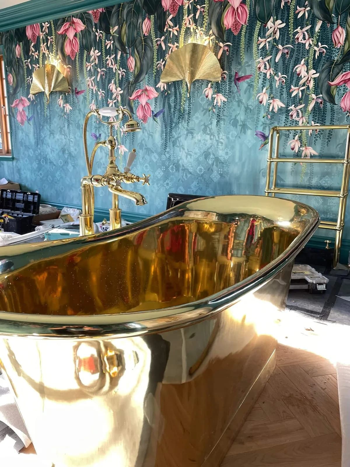 Detail of hand-hung floral mural wallpaper and brass wall lights, Bourne Decorators wallpapering project in Binstead, Hampshire